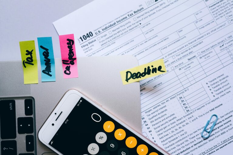 Tax paperwork with sticky notes and calculator