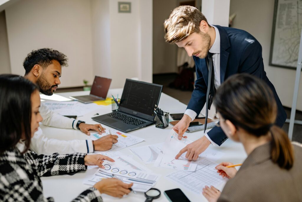 Corporate team reviewing paperwork evaluating M&A deal structure