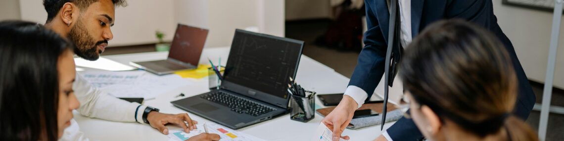 Corporate team reviewing paperwork evaluating M&A deal structure
