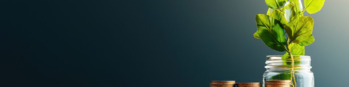 seed funding coins next to a small jar with a plant seedling growing