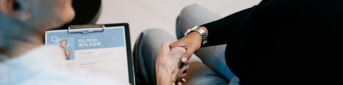 woman shaking hands after being offered a job during an interview