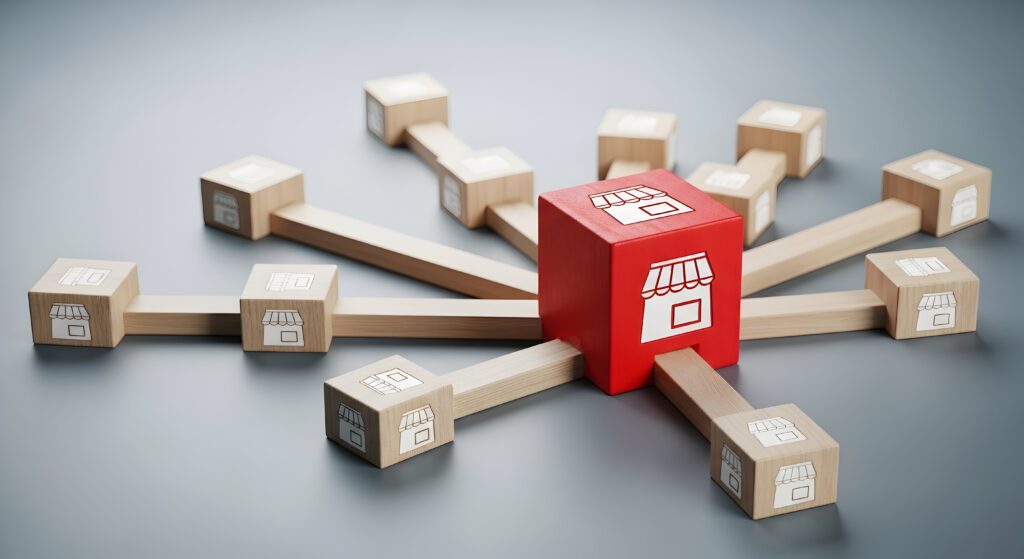 Business franchise expansion concept with connected wooden blocks and shop icons