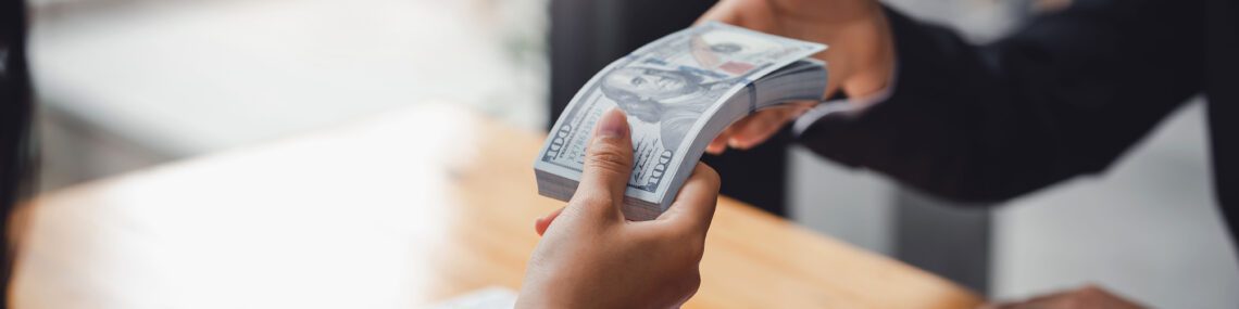 Business people exchanging cash for sale of business. Mergers and acquisitions.