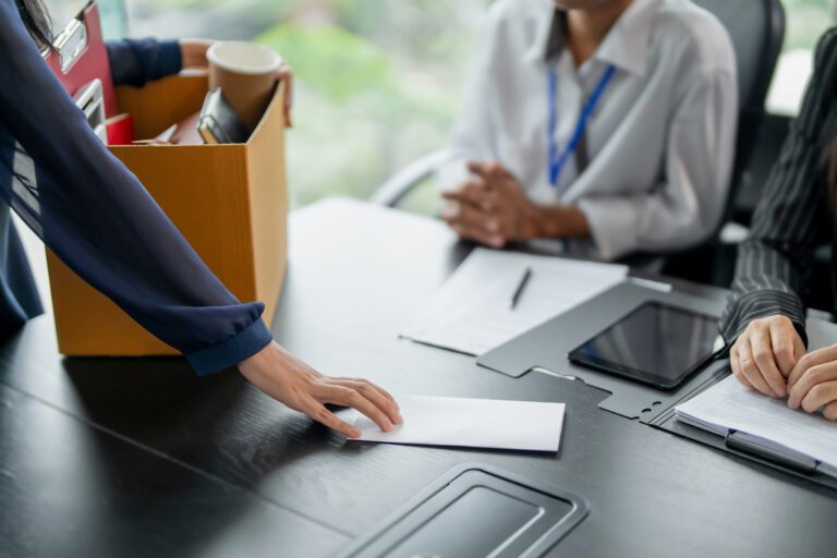 Business partner resigning from company ownership turning in resignation letter to partners