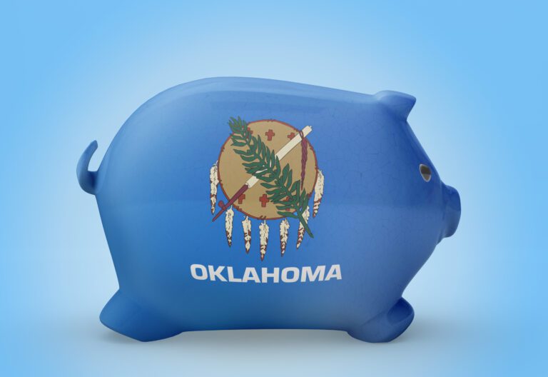 Side view of a piggy bank with the flag design of Oklahoma