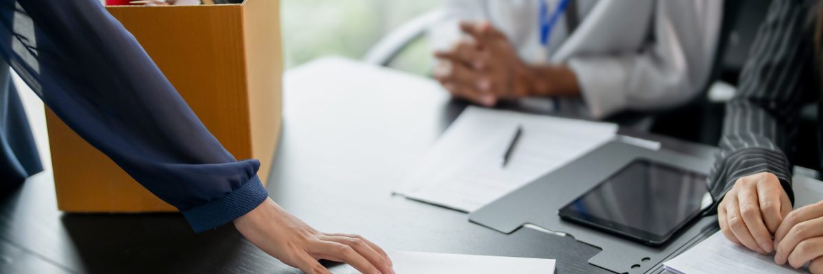 Business partner resigning from company ownership turning in resignation letter to partners
