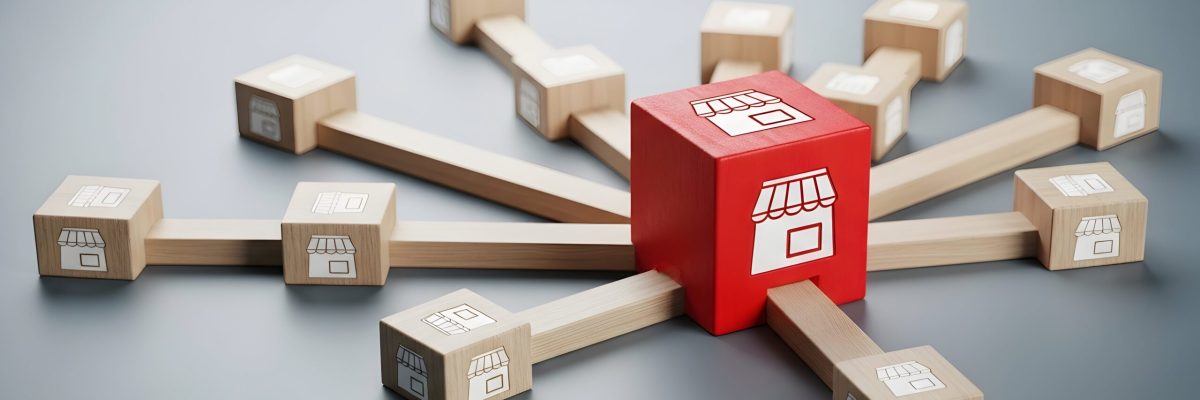 Business franchise expansion concept with connected wooden blocks and shop icons