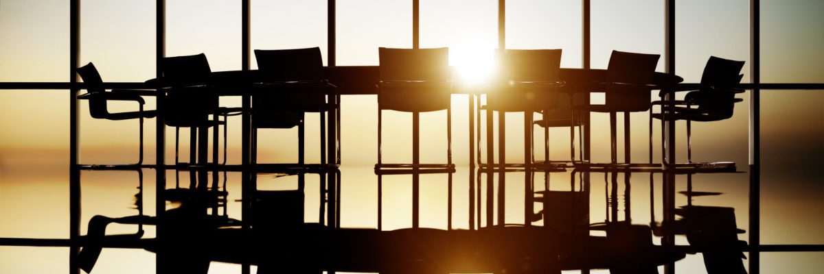 Corporate board of directors meeting room empty with sunlight coming through windows