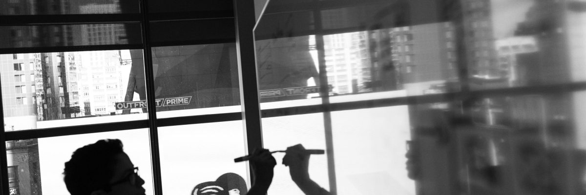 pexels-divinetechygirl-1181366 Black and white photo of founder writing business plans on whiteboard