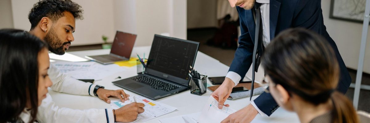 Corporate team reviewing paperwork evaluating M&A deal structure