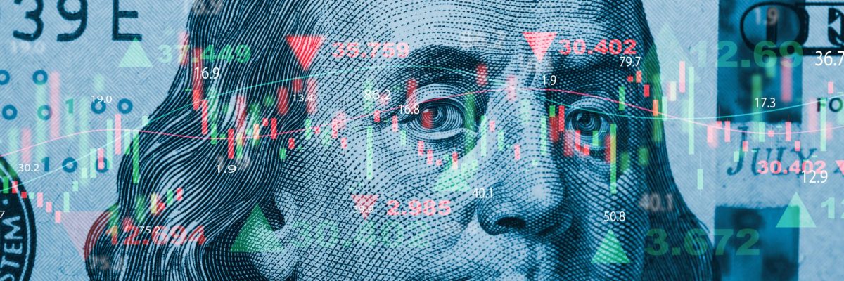 Closeup Benjamin Franklin face on USD banknote with stock market chart graph for currency exchange and global trade forex concept.