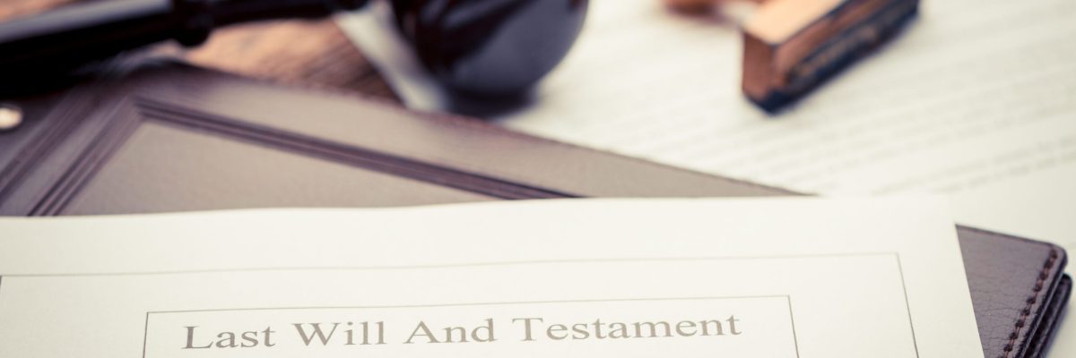 Last Will and testament document on wooden table close up